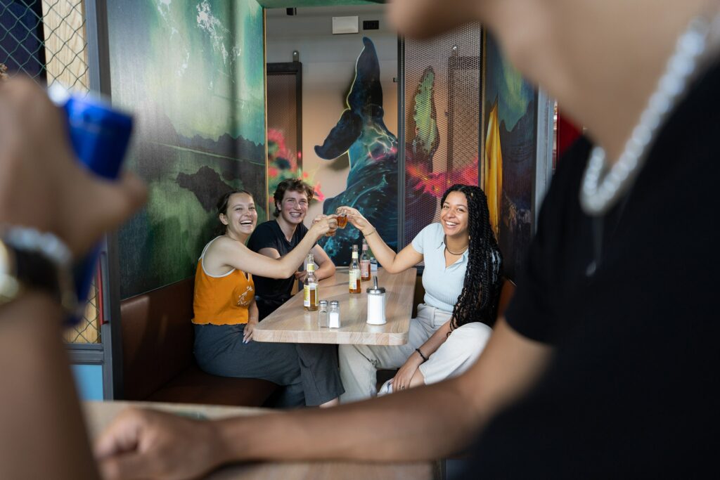 Gruppe von jungen Menschen sitzt am Tisch im Schulz Hotel Berlin Ostbahnhof